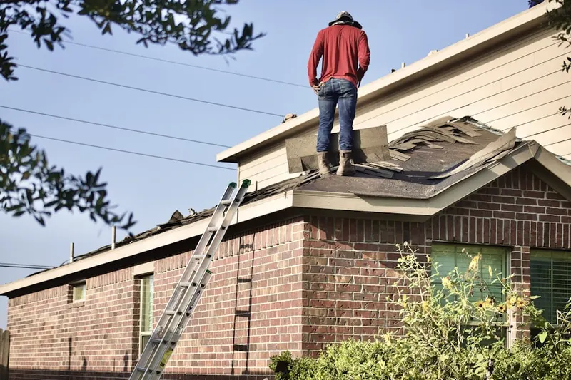 Professional roofer working on a residential roof in Freestate-North Highlands